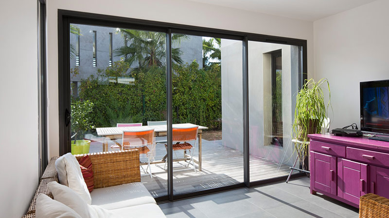 baie vitrée en aluminium pour accéder à la terrasse depuis le salon